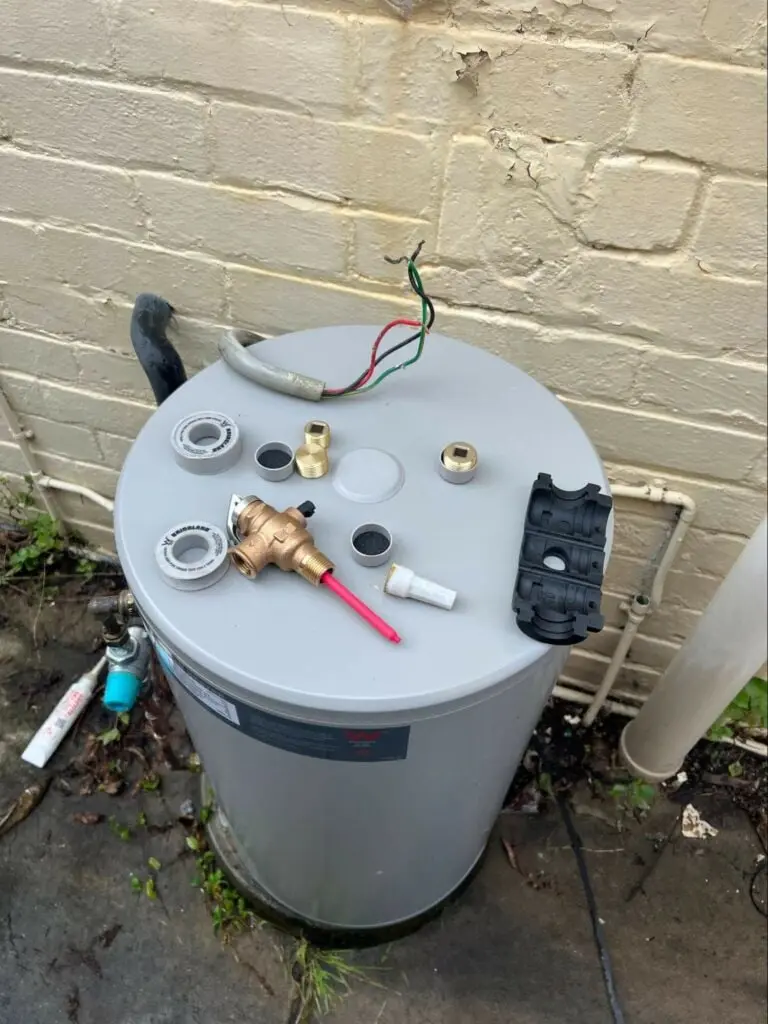 Valves and fittings laid on top of a new hot water unit before connection